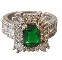 Front view showing green center stone and surrounding clear stones