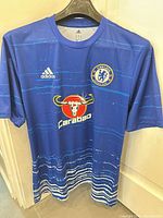 Front view showing Adidas logo, Chelsea crest, Carabao sponsor, design pattern