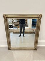 Front view of rectangular mirror with ornate gold frame