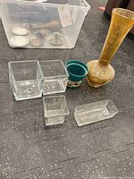 Group showing amber vase, clear glass containers, plastic pot