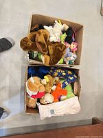Two boxes filled with assorted plush toys