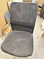 Front view of black mesh office chair showing mesh backrest and seat