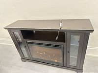 Full view of dark brown electric fireplace TV stand