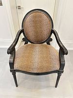 Front view of armchair showing upholstery and frame