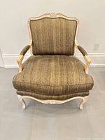 Front view of upholstered armchair showing overall design and condition