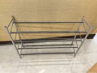 overall view of gray metal 4-tier shoe rack, freestanding