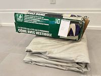 Damaged Hillary tent box beside folded tent fabric