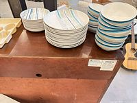 Stacks of dinner plates and bowls on cabinet