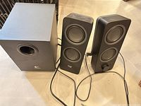 full view of subwoofer and both satellite speakers with cables