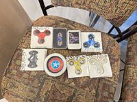 Overall view of seven packaged spinners on chair