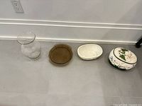 Group shot: clear glass vase, amber oval glass dish, white textured bowl, floral ceramic lidded jar