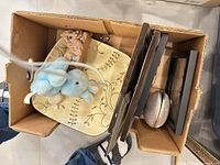 Top view of box showing plate, plush bunny, figurine, frames, trinket box