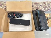 Receiver, center speaker and cables inside box