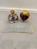 Overall view of both bottles on glass tray