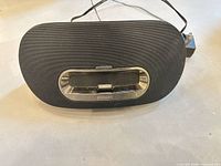 Front view of Philips docking speaker showing grille and 30-pin dock