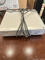 Front view of Philips PH1310 DVD player with cables on top