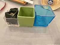 Top and side view of three square planters showing materials and colors