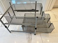 Side view showing full organizer with two mesh trays and frame