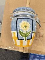 front view showing floral motif and lid mechanism