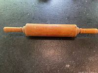 Full view of rolling pin showing handles and roller