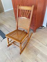 Full view of golden oak cane rocking chair