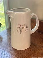 Front view of white Hall Pottery Schenley Whiskey pitcher