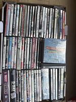 Top view of cardboard box filled with DVD cases showing quantity and variety