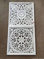 Both carved panels side by side to show full designs and scale
