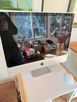 Front view of 2008 Apple iMac on desk, screen off
