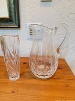 Pitcher and tall vase side by side on table
