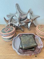 Group showing woven coasters, metal starfish, metal coasters