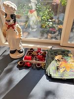 Overall lot showing figurine, napkins stack, tray of rings