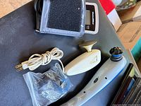 Group showing ChoiceMMed BP monitor with cuff, Oster massager, Wahl massager, extra heads and power cord