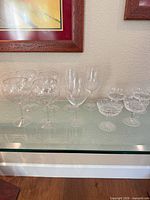 Full set of 11 crystal stemware on glass shelf