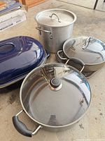Overall view of stock pot, roaster, two sauté pans with lids