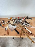 Entire mixed utensil lot spread on tabletop