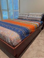 Overall view of bed with bedding and pillows