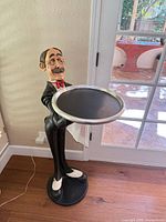 Front view showing full statue with tray