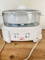 Front view of assembled Sunbeam Instant Steam steamer showing housing, basket and lid