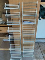 two white wire racks side by side showing full height and tier count