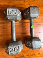 Pair of 20 lb cast iron hex dumbbells on wood floor