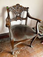 Front view of carved tiger oak armchair