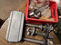 Overall lot with four strut assemblies, metal canister and red crate of parts