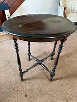 Full view of round wooden gateleg side table