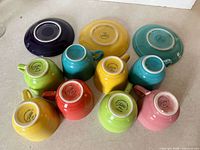 Undersides showing Fiesta marks: eight cups, three saucers