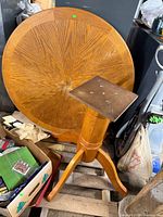 Round tabletop and pedestal base on pallet