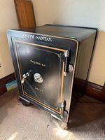 Front and side view showing overall safe, logo, and wheels