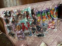 Full lot of sealed Teenie Beanie Babies spread on surface