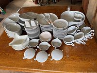 Full lot overview showing all melamine pieces stacked on table