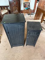 Both black wooden cabinets front view for size comparison